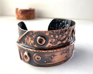 Copper fold formed textured cuff bracelet w/tactile braille "I am enough" in Contracted Braille. Antiqued, burnished, and polished.